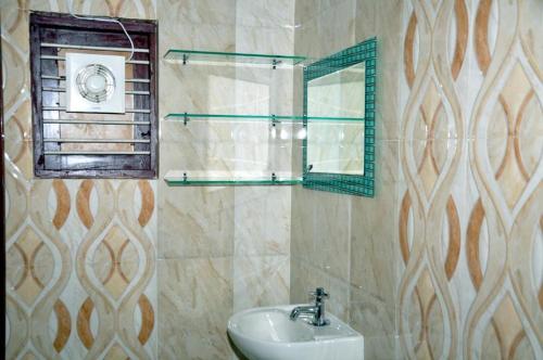 y baño con lavabo y espejo. en Keratheeram Beach Resort, en Varkala
