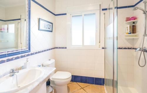 a bathroom with a toilet and a sink and a shower at la casita de la palmera in El Puerto de Santa María