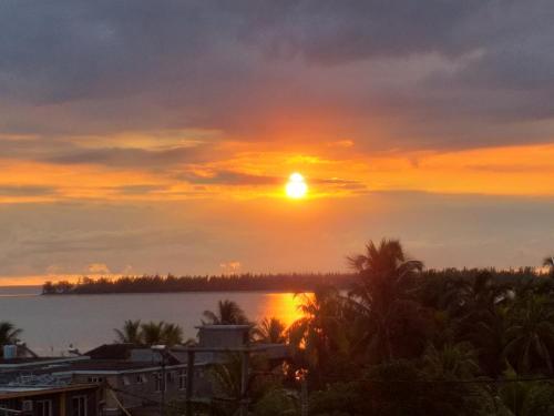 a sunset from the balcony of a house at Flo Villa in La Gaulette