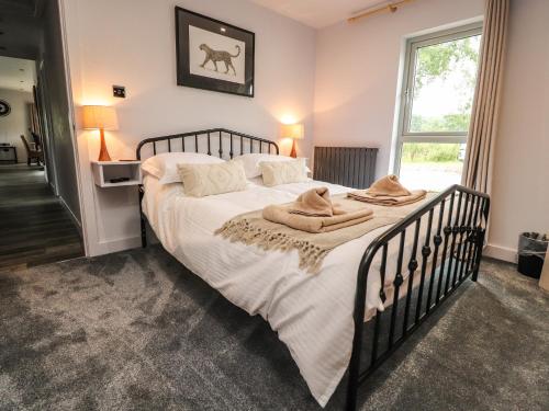 a bedroom with a large bed with towels on it at Box Tree Escapes in Lancaster