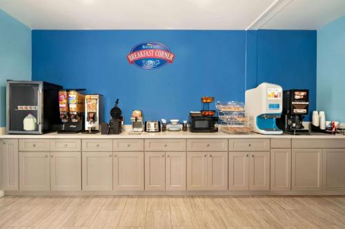 a coffee shop with a blue wall at Baymont by Wyndham Kingwood in Kingwood