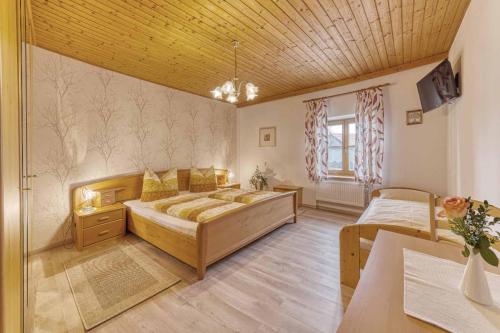 a large room with two beds and a table at Pension Zum Lebzelter in Freyung