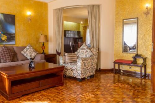a living room with a couch and a table at Mimosa Court Apartments in Nairobi