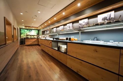 a kitchen with a long counter with sinks in it at Das Waldhotel - Genuss & Wellness am Notschreipass in Todtnau