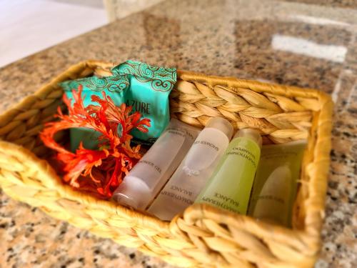 a basket filled with bottles of wine on a counter at Tourterelle Holiday Home in Grand Anse
