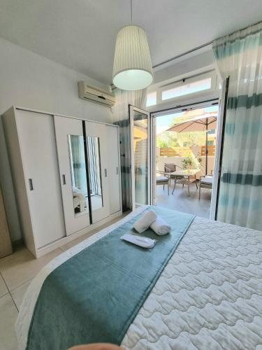 a bedroom with a large bed and a balcony at Harmony Residence in Kavos