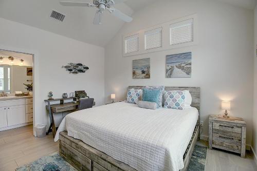 a bedroom with a bed and a desk and a sink at The Sassy Crab in Port Aransas
