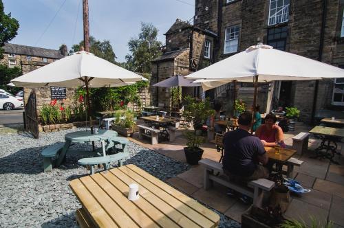 two people sitting at a table under umbrellas at The Royal Hotel and Bar in Lancaster