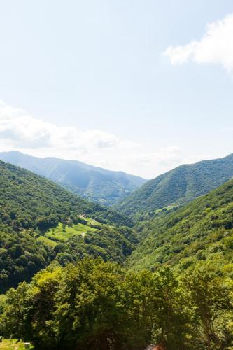 a view of a valley with mountains in the distance at Ostello Scudellate MONTE GENEROSO in Scudellate