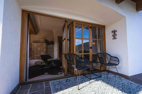 a room with a table and chairs and a window at Chalet Crown of the Alps by we rent in Zell am See
