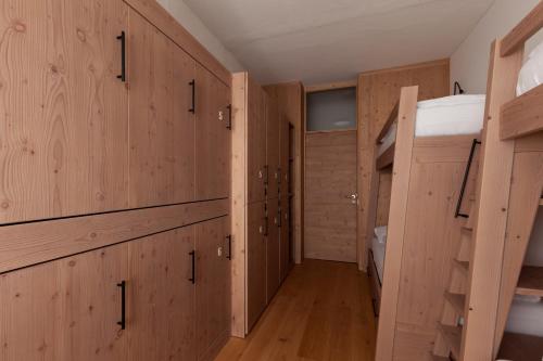 a room with wooden walls and wooden floors at Ostello Scudellate MONTE GENEROSO in Scudellate