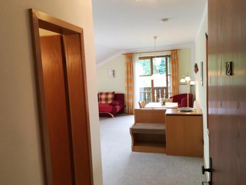 a room with a living room with a couch and a table at Gästehaus Bauer am Golfplatz in Prien am Chiemsee