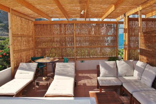 a screened in patio with white chairs and a table at Santa Irene in Sougia