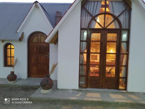 a house with a wooden door and windows at Hotel Nido del Flamenco in Uyuni