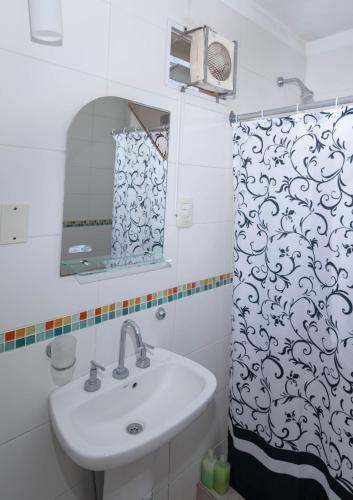 a bathroom with a sink and a shower curtain at Complejo Paradise in Colón