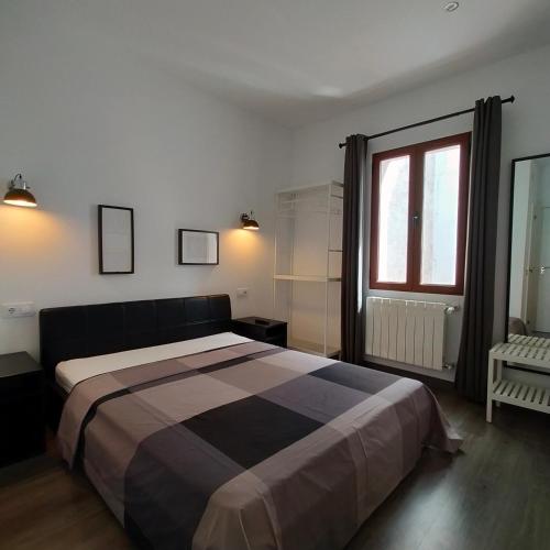 a bedroom with a large bed and a window at Room Pride in Madrid