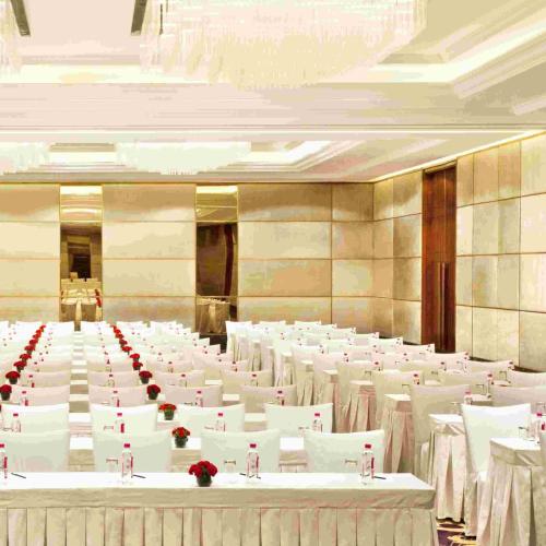 a large banquet hall with white tables and chairs at Holiday Inn New Delhi Mayur Vihar Noida by IHG in New Delhi