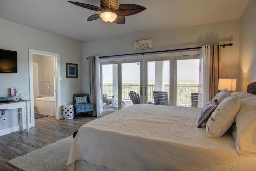 a bedroom with a large bed and a balcony at The Pearl of Port A GW108 in Port Aransas
