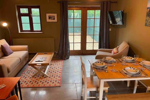 a living room with a table and a couch at Cottage With Hot Tub in Pembrokeshire in Haverfordwest
