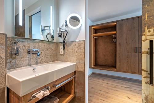 a bathroom with a sink and a mirror at Hotel Stern in Ehrwald