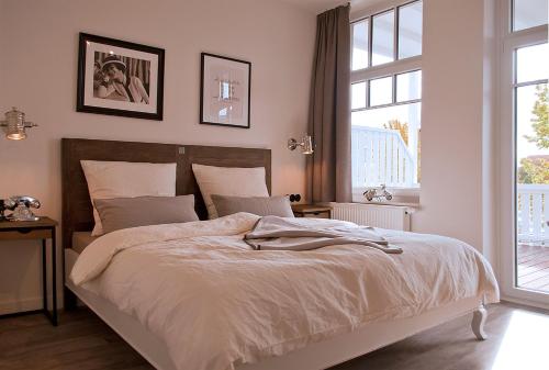 a bedroom with a large bed and a window at Weyotel in Weyhe