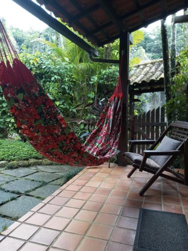 a hammock on the porch of a house at Pousada Cachoeira in Abraão