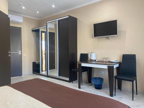 a room with a desk and a tv on the wall at Міні-готель "Кімната Комфорт" in Odesa