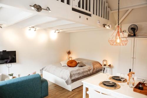 a bedroom with a bed and a blue couch at Morning Glory in Wemeldinge
