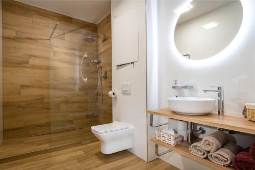 a bathroom with a toilet and a sink and a shower at Apartment PEAK - Apartmany Bernard Stary Smokovec in Vysoke Tatry - Novy Smokovec