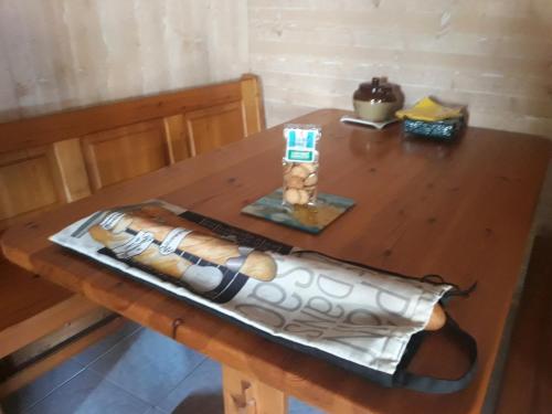 a wooden table with a candle on top of it at La maison neuve in Fontaines