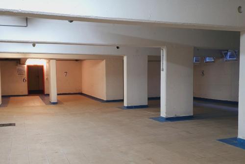 an empty room with white pillars in a building at Residence Silvester in Racines