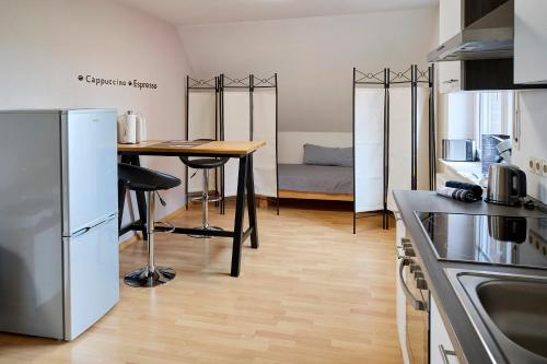 a kitchen with a table and a bed in a room at Luxury Apartment Kampe in Stemwede
