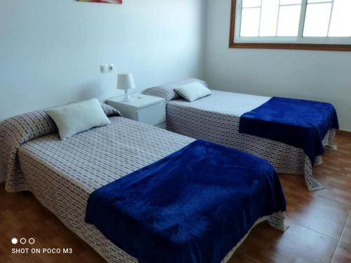 Un pat sau paturi într-o cameră la CASA PASAXE-Bajo