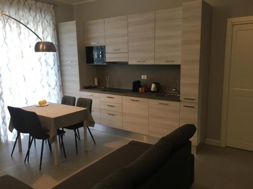 a kitchen with a table and chairs and a kitchen with cabinets at SAN FRANCESCO Apartment in Turin