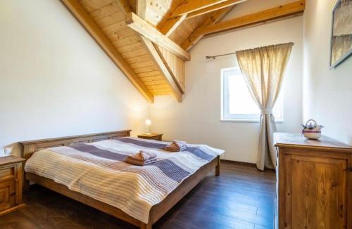 a bedroom with a bed and a window at Apartmán pod orechom in Drienica