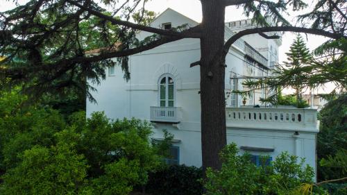 a white building with a balcony on top of it at Villa Manning Relais in Sorrento