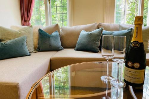 a bottle of wine sitting on a table next to a couch at Nomi Homes - Otis House - Free Parking - Central -10ppl in Exeter