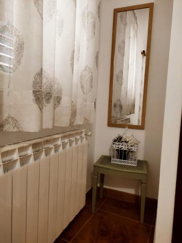 a bathroom with a radiator and a table and a mirror at Pitões NatureHouse in Pitões das Júnias