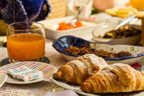 a table topped with plates of pastries and orange juice at Villa Manning Relais in Sorrento
