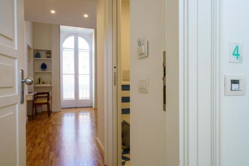a hallway with a door leading to a room with a window at Villa Manning Relais in Sorrento