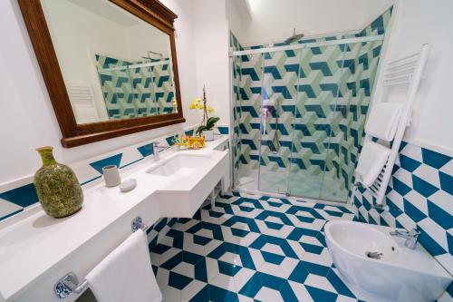 a bathroom with a blue and white checkered floor at Villa Manning Relais in Sorrento