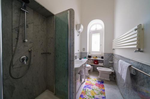 a bathroom with a shower and a sink and a toilet at Villa Manning Relais in Sorrento