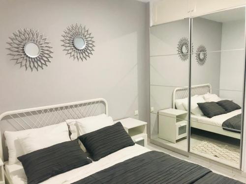 a bedroom with a bed and mirrors on the wall at Olas de Lobos in Corralejo