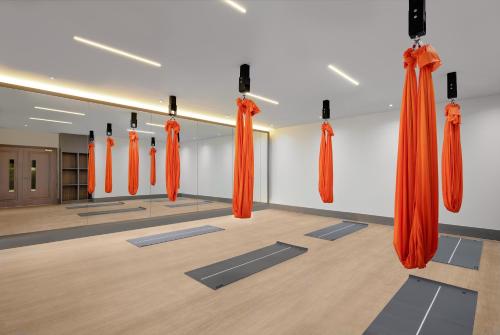 an empty room with orange curtains and yoga mats at Fairmont Windsor Park in Windsor