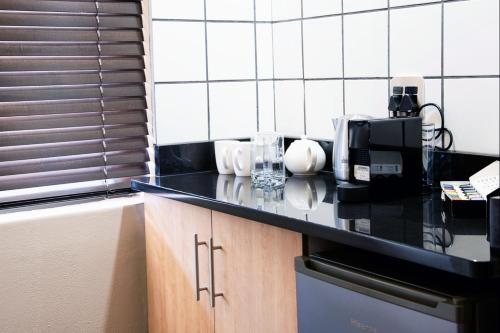 a kitchen with a counter top with a coffee maker at Schimper View Boutique Guest House in Louis Trichardt