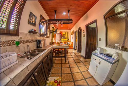 a kitchen with a sink and a counter at Sol y Luna Apartments in Fortuna