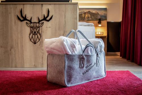 a bag sitting on the floor in a hotel room at Arcus Hotel München Messe in Feldkirchen