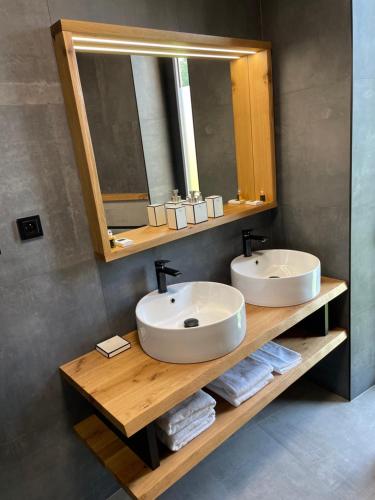 a bathroom with two sinks and a mirror at Panorama Kořenec in Kořenec