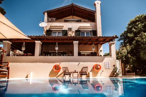 uma casa com piscina em frente a uma casa em Villa Butterfly - Heated Private Pool & Jacuzzi em Corfu Town