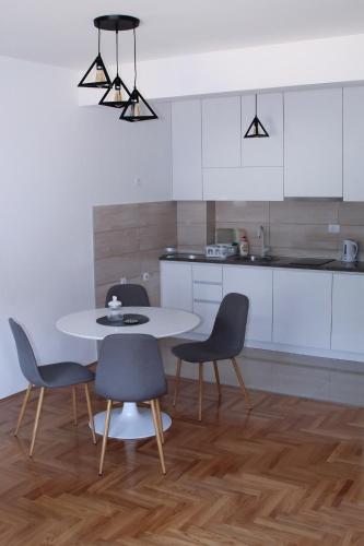 una cucina con un tavolo e sedie in una stanza di Apartman Vuković a Trebinje